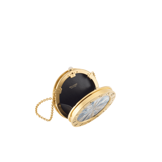 The Bvlgari Icons Minaudière Limited Edition collection reinterprets Bvlgari's timeless symbols, bridging the universes of jewellery and accessories with designs that embody both heritage and innovation. The BVLGARI BVLGARI Minaudière features a sleek cylindrical silhouette crafted in gold-finished aluminium and brass, with refined intarsia mother-of-pearl inserts framed by the signature double logo engraving. The creation is completed by a chain for hand-carry and features a single compartment with black nappa leather lining and a press-button closure. A refined objet d'art, the minaudière is accompanied by a specially designed miniature book, ‘Notes on Creating Culture’ by Chimamanda Ngozi Adichie, perfectly designed to fit its shape. Made in Italy. 295247 image 3