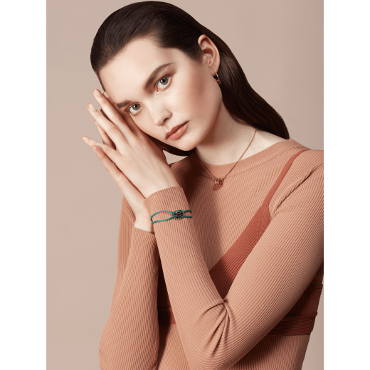Serpenti Forever bracelet in emerald green fabric. Light gold-plated brass captivating snakehead décor embellished with emerald green and black enamel scales, and black enamel eyes. SERP-STRINGd image 2