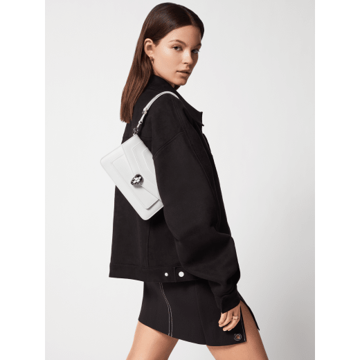 Serpenti Forever East-West small shoulder bag in black calf leather with emerald green gros grain lining. Captivating snakehead magnetic closure in light gold-plated brass embellished with black and white agate enamel scales, and green malachite eyes. 1237-CLa image 1