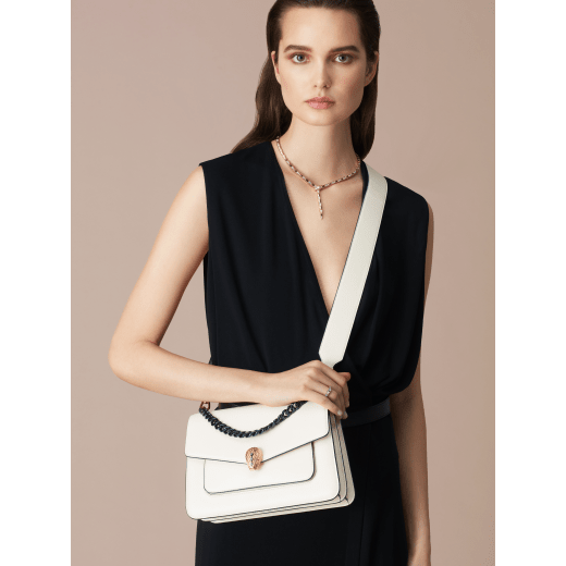 "Serpenti Forever" maxi chain crossbody bag in Ivory Opal white nappa leather, with an Deep Garnet bordeaux nappa leather internal lining. New Serpenti head closure in gold-plated brass, finished with small grey mother-of-pearl scales in the middle, and red enamel eyes. 1138-MCNb image 5