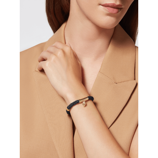 Serpenti Forever bracelet in black woven fabric. Captivating snakehead charm in gold-plated brass embellished with red enamel eyes, and press-button closure. SERPMULTISTRING-WF-B image 2