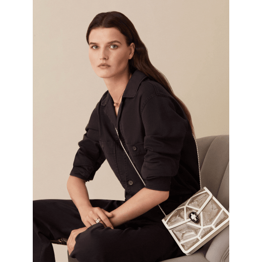 “Serpenti Forever” crossbody bag in black calf leather with a Million Chain motif. Iconic snake head closure in light gold plated brass enriched with black enamel and black onyx eyes. 422-CP image 6