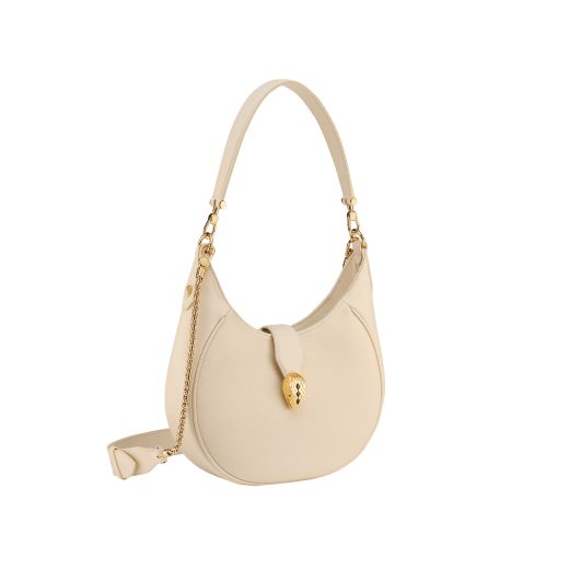 Serpenti Ellipse medium shoulder bag in Urban grain and smooth ivory opal calf leather with flamingo quartz pink gros grain lining. Captivating snakehead closure in gold-plated brass embellished with black onyx scales and red enamel eyes. 1190-UCL image 4