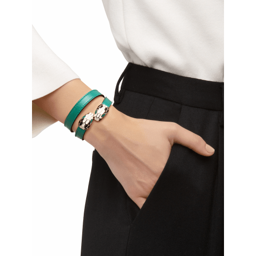 Serpenti Forever two-coil bracelet in emerald green calf leather. Captivating single-rivet contraire snakehead closure in light gold-plated brass embellished with black and white agate enamel scales and green enamel eyes. MCSerp-CL-EG image 1