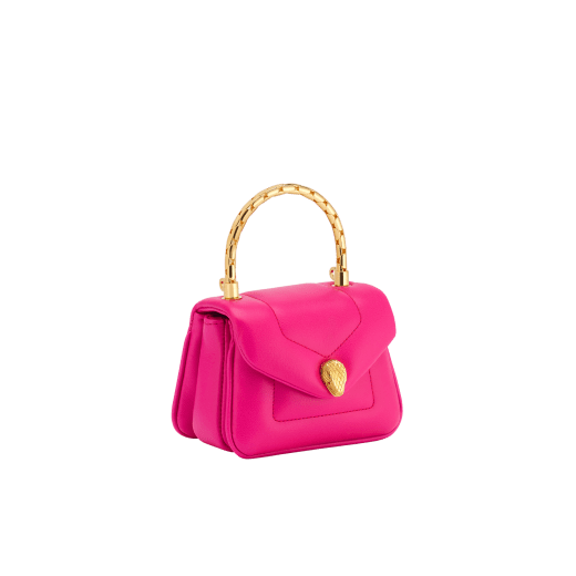 Serpenti Reverse micro top handle bag in truly tourmaline fuchsia Metropolitan calf leather with royal ruby red nappa leather lining. Captivating snakehead magnetic closure in gold-plated brass embellished with red enamel eyes. SRV-NANOREVERSE-MCL image 3