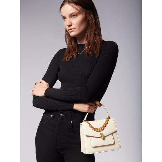"Serpenti Forever" small maxi chain top-handle bag in black nappa leather, with black nappa leather inner lining. New Serpenti head closure in gold-plated brass, finished with small black onyx scales in the middle, and red enamel eyes. 1133-MCNb image 5