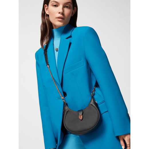 Serpenti Ellipse small crossbody bag in Urban grain and smooth ivory opal calf leather with flamingo quartz pink gros grain lining. Captivating snakehead closure in gold-plated brass embellished with black onyx scales and red enamel eyes. 1204-UCL image 8