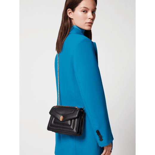Serpenti Reverse small shoulder bag in ivory opal quilted Metropolitan calf leather with black nappa leather lining. Captivating snakehead magnetic closure in gold-plated brass embellished with red enamel eyes. 1244-MCL image 7
