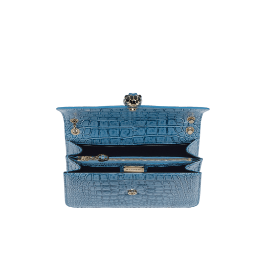 Serpenti Forever shoulder bag in Niagara sapphire blue Cloudy alligator skin with black nappa leather lining. Captivating snakehead closure in light gold-plated brass embellished with black enamel scales, blue jade scales in the centre and black onyx eyes. 1140HE-A image 5