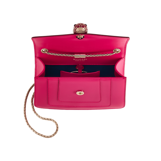 Serpenti Forever small crossbody bag in vivid emerald green calf leather with beet amethyst fuchsia grosgrain lining. Captivating snakehead magnetic closure in light gold-plated brass embellished with bright forest emerald green enamel and light gold-plated brass scales, and black onyx eyes. 422-CLc image 4