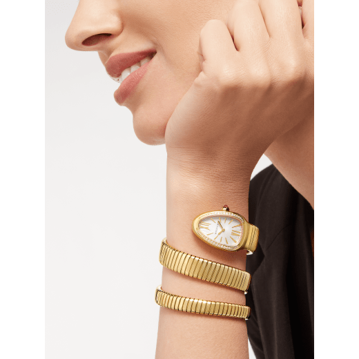 Serpenti Tubogas Lady watch, 35 mm 18 kt yellow gold curved case set with diamonds, 18 kt yellow gold crown set with a cabochon cut pink rubellite, silver opaline dial with guilloché soleil treatment and hand-applied indexes, double spiral 18 kt yellow gold bracelet. Quartz movement, hours and minutes functions. Water proof 30 m. 101923 image 1