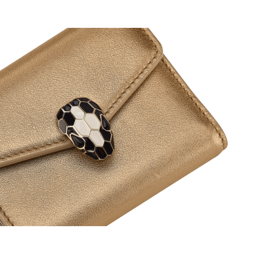 Serpenti Forever slim compact wallet in emerald green calf leather with black nappa leather interior. Captivating snakehead press button closure in light gold-plated brass embellished with black and white agate enamel scales and black onyx eyes. SEA-SLIMCOMPACT-Clb image 4