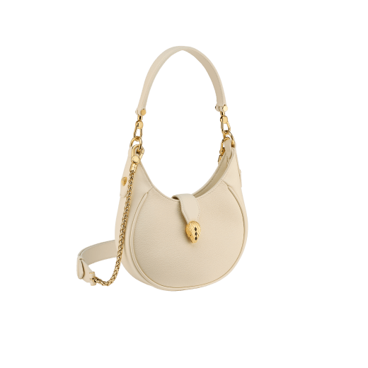 Serpenti Ellipse small crossbody bag in Urban grain and smooth ivory opal calf leather with flamingo quartz pink gros grain lining. Captivating snakehead closure in gold-plated brass embellished with black onyx scales and red enamel eyes. 1204-UCL image 3