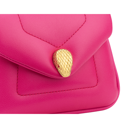 Serpenti Reverse micro top handle bag in truly tourmaline fuchsia Metropolitan calf leather with royal ruby red nappa leather lining. Captivating snakehead magnetic closure in gold-plated brass embellished with red enamel eyes. SRV-NANOREVERSE-MCL image 4
