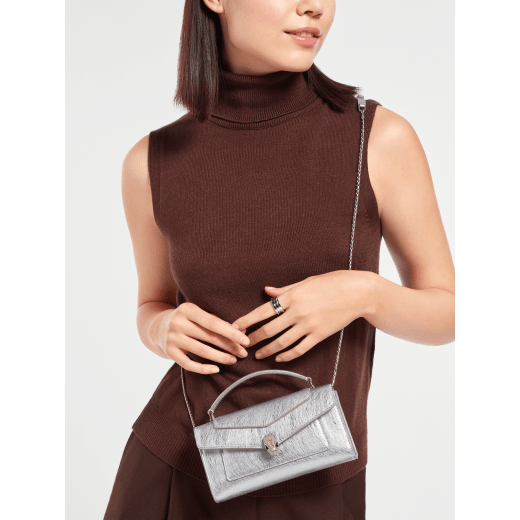 Serpenti Forever phone case in flash diamond calf leather with emerald green nappa leather lining. Captivating snakehead magnetic closure in palladium-plated brass embellished with white enamel and palladium-plated brass scales, and black onyx eyes. SEA-PHONEPOUCH image 1