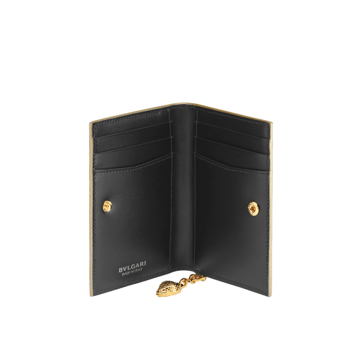"Serpenti Forever" bi-fold card holder in "Molten" gold karung skin and black calfskin, offering a touch of radiance for the Winter Holidays. New Serpenti head charm in gold-plated brass, complete with ruby-red enamel eyes. SEA-CC-HOLDER-FOLD-MoltK image 3