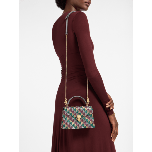 Serpenti Forever mini top handle bag with multicoloured Calla Crystals pattern and black nappa leather lining. Captivating snakehead magnetic closure in gold-finished brass embellished with diamond-cut engraving on the scales and black onyx eyes. SEA-001-1283XS-crys image 1