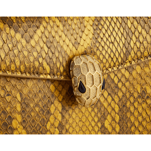 Serpenti Forever mini crossbody bag in gold-shaded python skin with 24 kt gold treatment and black nappa leather lining. Captivating snakehead magnetic closure in gold-plated brass including 3 µ of 24 kt gold and embellished with "diamantatura" engraving on the scales and black onyx eyes. Exclusive Bulgari 50th anniversary in the US Edition. 292592 image 5