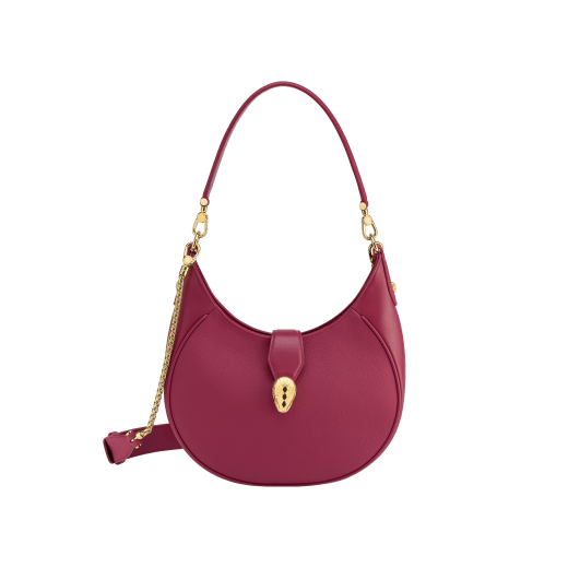 Serpenti Ellipse medium shoulder bag in Urban grain and smooth ivory opal calf leather with flamingo quartz pink gros grain lining. Captivating snakehead closure in gold-plated brass embellished with black onyx scales and red enamel eyes. 1190-UCL image 1