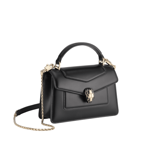 Serpenti Forever mini top handle bag in black calf leather with black nappa leather lining. Captivating snakehead magnetic closure in light gold-plated brass embellished with black enamel and light gold-plated brass scales, and black onyx eyes. SEA-1283-CL image 2
