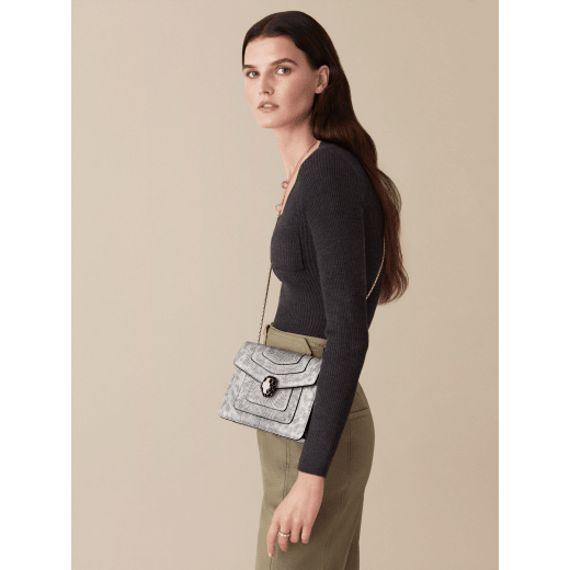 “Serpenti Forever” crossbody bag in white agate metallic karung skin. Iconic snakehead closure in light gold plated brass enriched with black and white agate enamel and black onyx eyes. 422-MK image 6