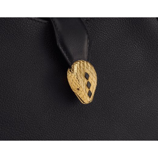 Serpenti Ellipse small crossbody bag in Urban grain and smooth ivory opal calf leather with flamingo quartz pink grosgrain lining. Captivating snakehead closure in gold-plated brass embellished with black onyx scales and red enamel eyes. 1204-UCL image 6
