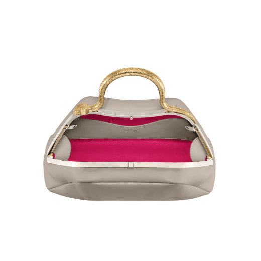 Serpentine small top handle bag in foggy opal grey smooth calf leather with beetroot spinel fuchsia nappa leather lining. Captivating snake body-shaped top handle in gold-plated brass embellished with engraved scales and red enamel eyes, press button closure and light gold-plated brass hardware. SRN-1268b image 4