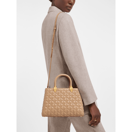 Serpentine Day Duo top handle bag in black calf leather with Calla matelassé motif and black nappa leather lining. Captivating double-head snake body-shaped handles in gold-plated brass embellished with matching calf leather inserts. SRN-001-1315M image 1