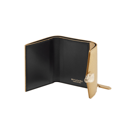 "Serpenti Forever" slim compact wallet in soft emerald green calf leather and black nappa leather. Iconic light gold-plated brass snakehead stud closure, finished with black and white agate enamel, and green malachite eyes. SEA-SLIMCOMPACT-Cla image 2