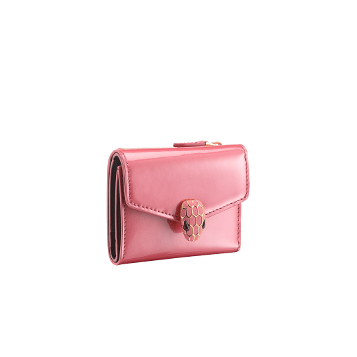 "Serpenti Forever" slim compact wallet in Blush Quartz pink calf leather with a varnished and pearled effect and black calf leather. Tempting gold plated brass snakehead stud closure, finished with matte Blush Quartz pink enamel, and black enamel eyes. SEA-SLIMCOMPACT-VCLa image 1
