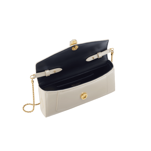 Serpenti Forever phone case in white agate varnished calf leather with black nappa leather lining. Captivating snakehead magnetic closure in gold-plated brass embellished with white agate enamel and gold-plated brass scales, and black onyx eyes. 295159 image 3