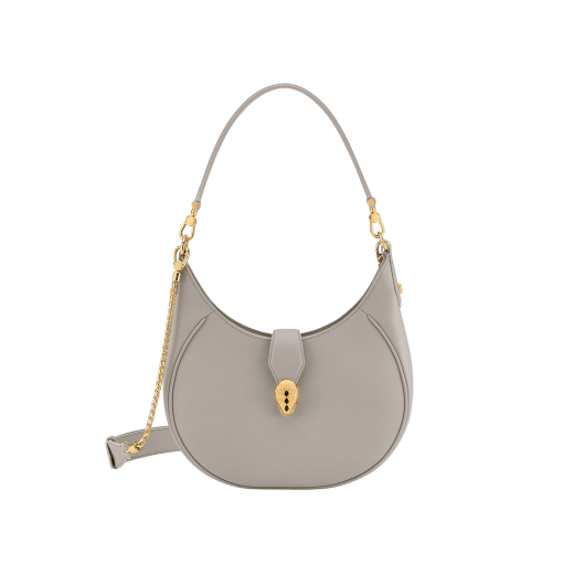 Serpenti Ellipse medium shoulder bag in Urban grain and smooth Niagara sapphire blue calf leather with cloud topaz blue grosgrain lining. Captivating snakehead closure in gold-plated brass embellished with black onyx scales and red enamel eyes. 1190-UCL image 1