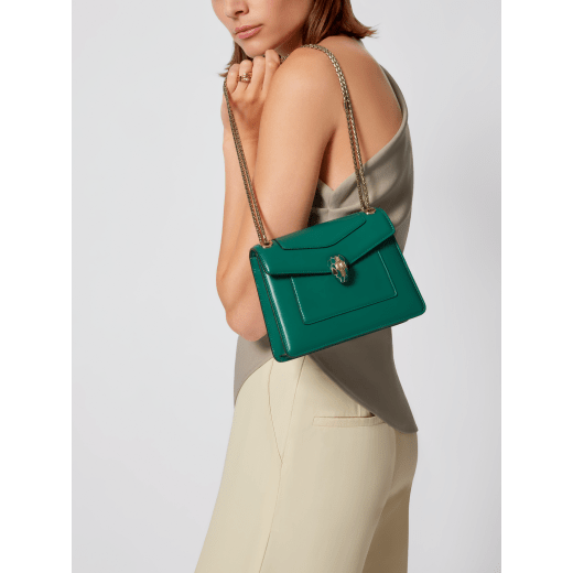Serpenti Forever Day-to-Night small shoulder bag in emerald green calf leather with black nappa leather lining. Captivating snakehead magnetic closure in light gold-plated brass embellished with deep jade intense green enamel and light gold-plated brass scales, and black onyx eyes. SEA-1281-CL image 1