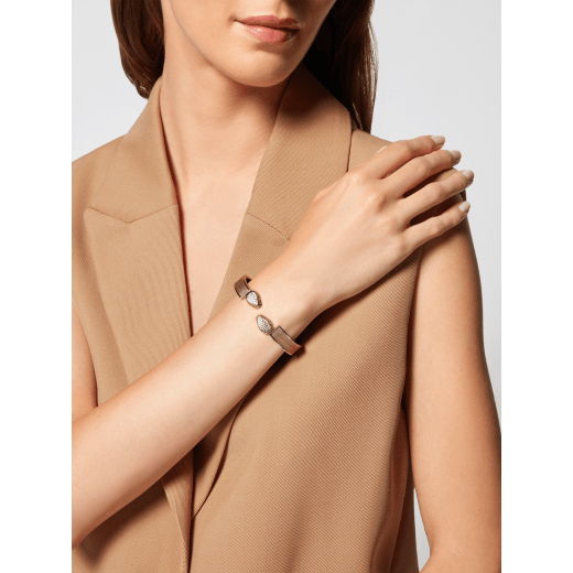 Serpenti Forever bangle bracelet in light gold-plated brass with antique gold Liquid Metal calf leather inserts. Captivating double snakehead hinge closure in light gold-plated brass embellished with red enamel eyes. SERPHINGE-LMCL-AG image 1