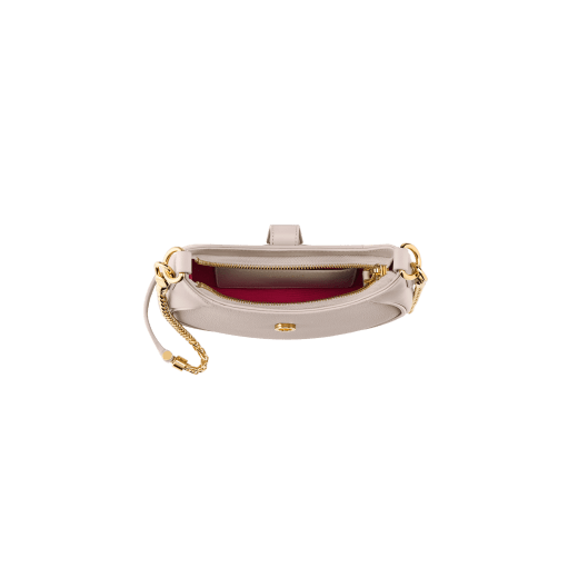 Serpenti Ellipse small crossbody bag in Urban grain and smooth flamingo quartz pink calf leather with flamingo quartz pink gros grain lining. Captivating snakehead closure in gold-plated brass embellished with black onyx scales and red enamel eyes. Online exclusive colour. 1204-UCLa image 4