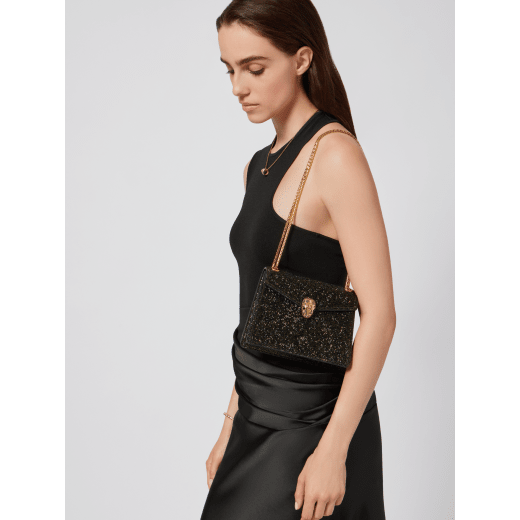 Serpenti Forever Day-to-Night small shoulder bag with black crystals inserts hand-set on suede leather with black nappa leather lining. Captivating snakehead magnetic closure in gold-plated brass embellished with black zirconia pavé and gold-plated brass scales, and black onyx eyes. 294042 image 1