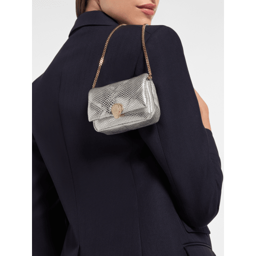 Serpenti Cabochon micro bag in ivory opal calf leather with a maxi matelassé pattern and black nappa leather lining. Captivating snakehead closure in gold-plated brass embellished with red enamel eyes. SCB-NANOCABOCHONa image 1