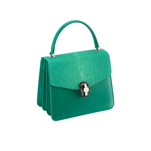 “Serpenti Forever ” crossbody bag in carmine jasper galuchat skin and calf leather. Iconic snakehead closure in light gold plated brass enriched with black and white enamel and green malachite eyes 752-Ga image 2
