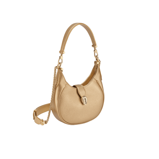 Serpenti Ellipse small crossbody bag in Urban grain and smooth ivory opal calf leather with flamingo quartz pink grosgrain lining. Captivating snakehead closure in gold-plated brass embellished with black onyx scales and red enamel eyes. 1204-UCL image 2