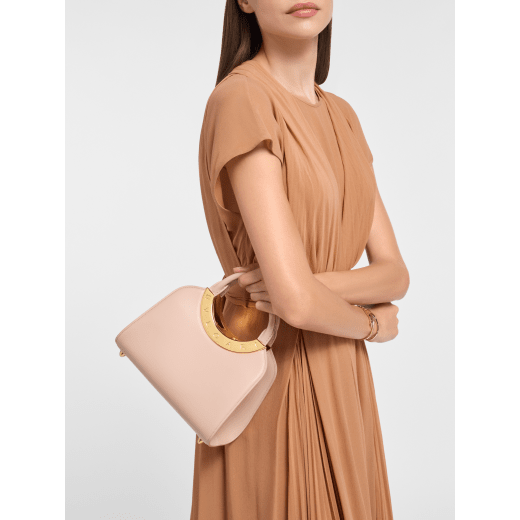 Bvlgari Roma small top handle bag in black Metropolitan calf leather with black nappa leather lining. Iconic metal detail in antique gold-plated brass engraved with the Bvlgari logo, and press button closure. BVR-001-1270S image 1