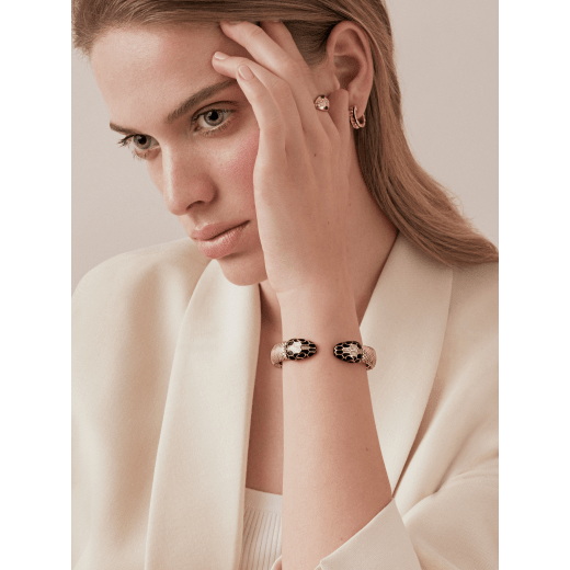 Serpenti Forever bangle bracelet in milky opal metallic karung skin, with brass light gold plated hardware. Iconic contraire snakehead décor in black and glitter milky opal enamel, with black enamel eyes. SPContr-MK-MO image 2
