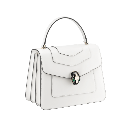 “Serpenti Forever” top handle bag in emerald green calf leather. Iconic snake head closure in light gold plated brass enhanced with black and white agate enamel and green malachite eyes. 1050-CL image 4