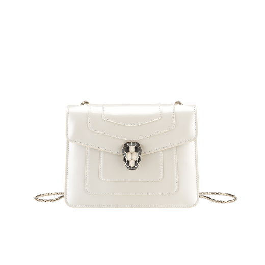 “Serpenti Forever” crossbody bag in agate-white calfskin with a polished, pearly finish and black grosgrain inner lining. Alluring snakehead closure in light gold-plated brass enriched with black and pearly, agate-white enamel and black onyx eyes 422-VCL image 1