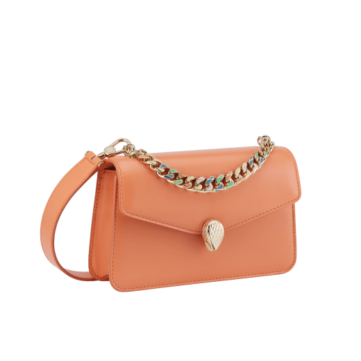 "Serpenti Forever" maxi chain pochette in Blush Quartz pink calf leather and Deep Garnet burgundy nappa leather. New Serpenti head closure in gold-plated brass, finished with red enamel eyes. SEA-XLCHAINPOUCH image 1