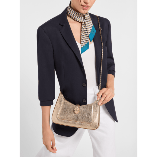 Serpenti Baia small shoulder bag in silver Striated calf leather with foggy opal grey nappa leather lining. Captivating snakehead magnetic closure in light gold-plated brass embellished with brushed grey enamel and light gold-plated brass scales and black onyx eyes; additional zipped top closure. SEA-001-1274S-STRI image 1
