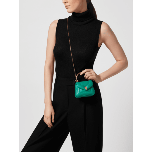 Serpenti Reverse micro top handle bag in truly tourmaline fuchsia Metropolitan calf leather with royal ruby red nappa leather lining. Captivating snakehead magnetic closure in gold-plated brass embellished with red enamel eyes. SRV-NANOREVERSE-MCL image 1