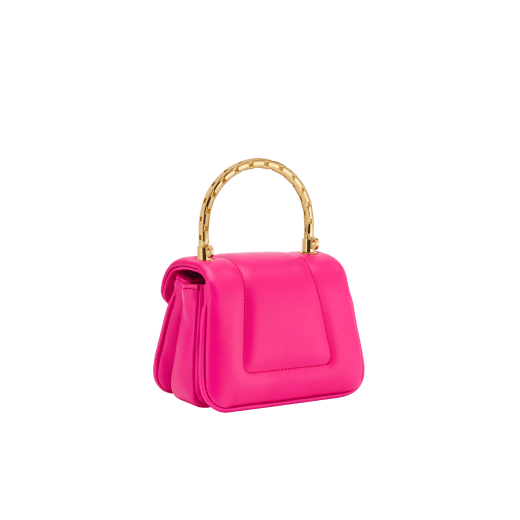 Serpenti Reverse micro top handle bag in truly tourmaline fuchsia Metropolitan calf leather with royal ruby red nappa leather lining. Captivating snakehead magnetic closure in gold-plated brass embellished with red enamel eyes. SRV-NANOREVERSE-MCL image 5