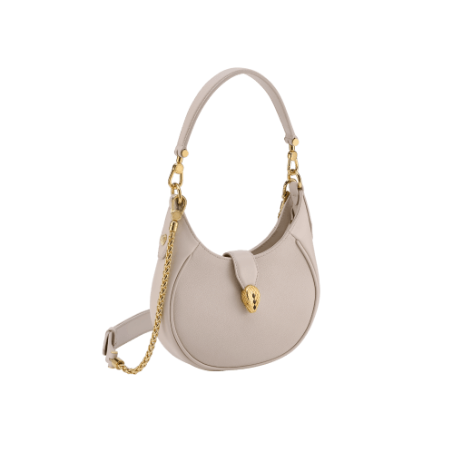 Serpenti Ellipse small crossbody bag in Urban grain and smooth ivory opal calf leather with flamingo quartz pink gros grain lining. Captivating snakehead closure in gold-plated brass embellished with black onyx scales and red enamel eyes. 1204-UCL image 2