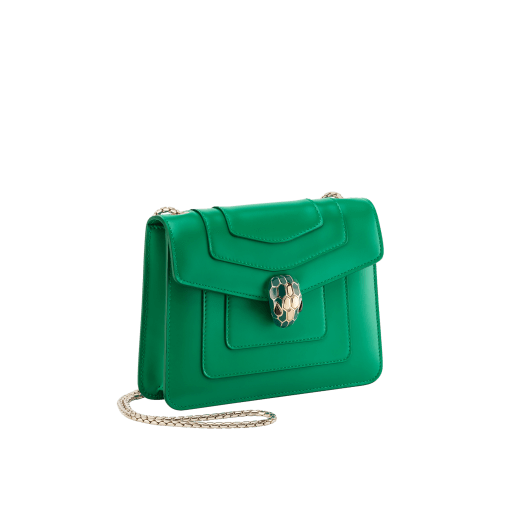 Serpenti Forever small crossbody bag in vivid emerald green calf leather with beet amethyst fuchsia grosgrain lining. Captivating snakehead magnetic closure in light gold-plated brass embellished with bright forest emerald green enamel and light gold-plated brass scales, and black onyx eyes. 422-CLc image 2