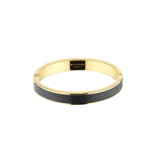 "BVLGARI BVLGARI" bangle bracelet in gold plated brass with a Moon Silver black metallic karung skin insert and a BVLGARI logo hinge closure. Logo engraving along the edges of both sides of the bracelet and in the inner part. HINGELOGOBRCLT-MK-B image 1